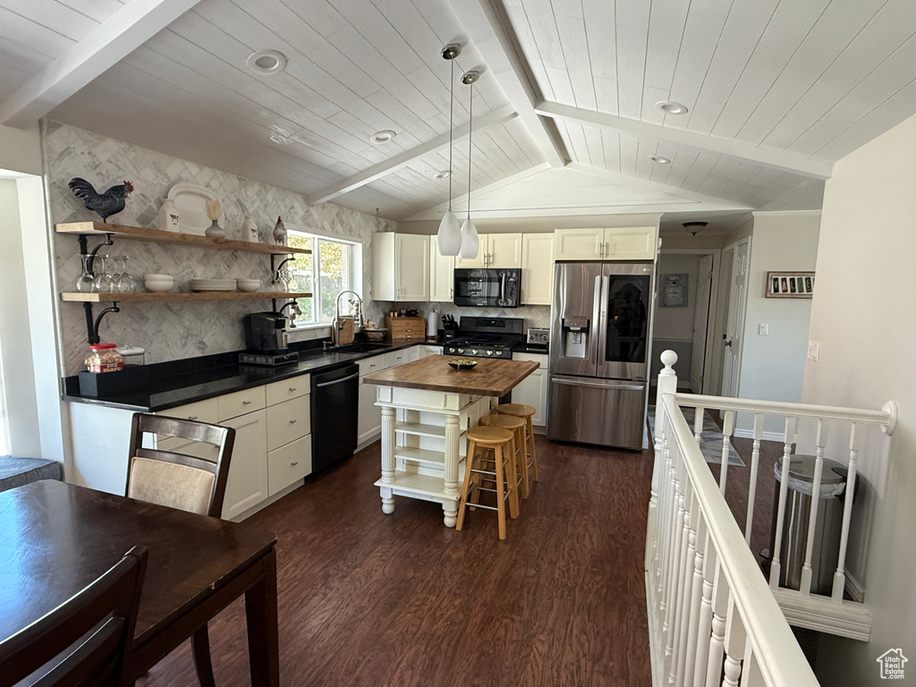 Kitchen featuring open shelves, dark wood-style floors, lofted ceiling with beams, wood counters, and black appliances