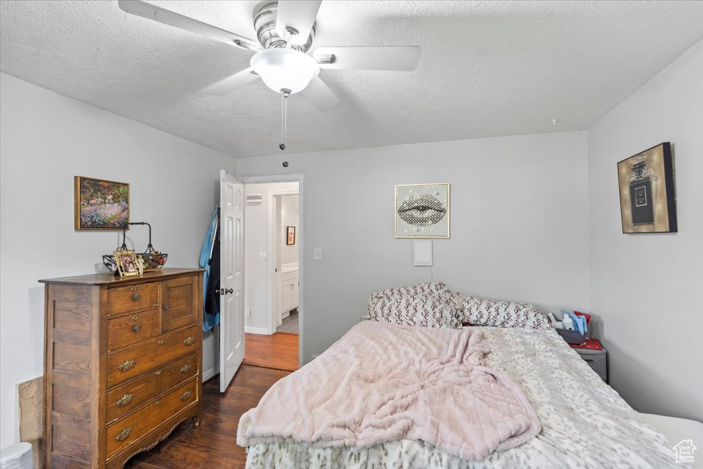 Bedroom with dark wood-style flooring and ceiling fan