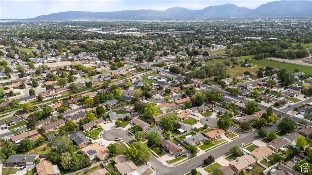 Aerial view of property and surrounding area featuring a mountainous background