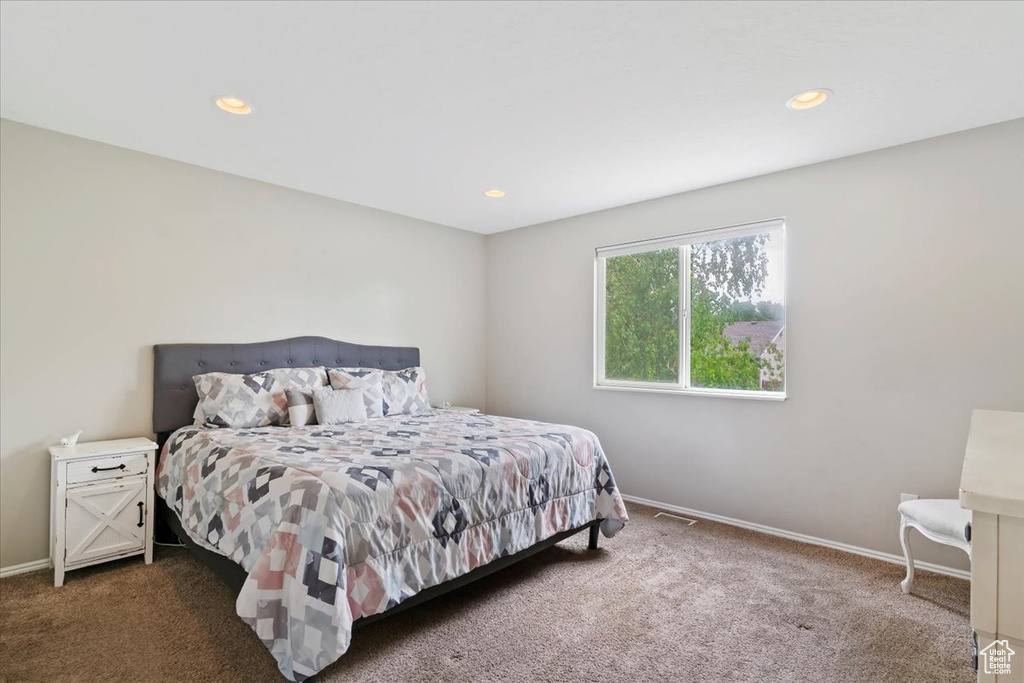 Bedroom with carpet flooring, baseboards, and recessed lighting