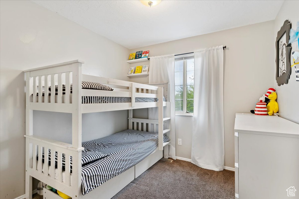 Bedroom featuring baseboards and carpet floors