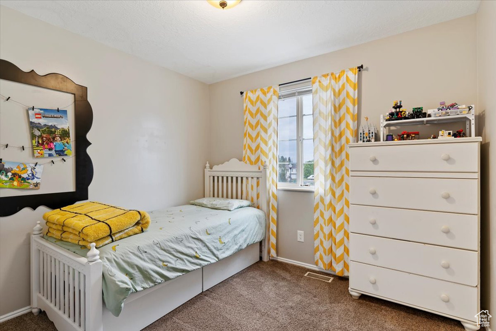 Bedroom featuring carpet, visible vents, and baseboards