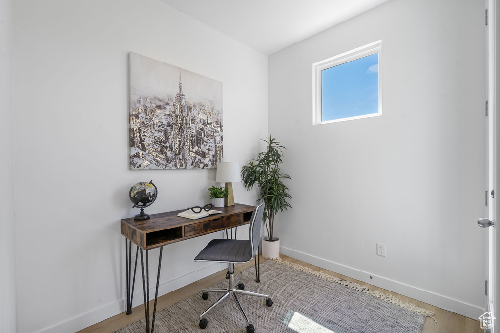 Office with baseboards and wood finished floors