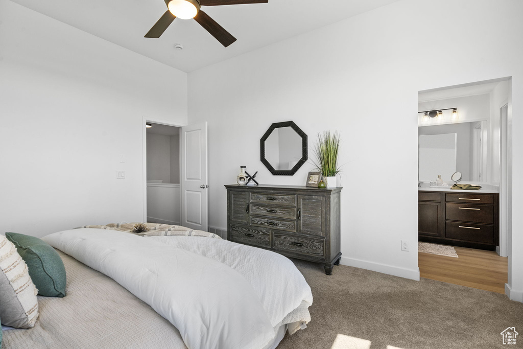 Bedroom with a ceiling fan, wet bar, baseboards, ensuite bathroom, and light carpet