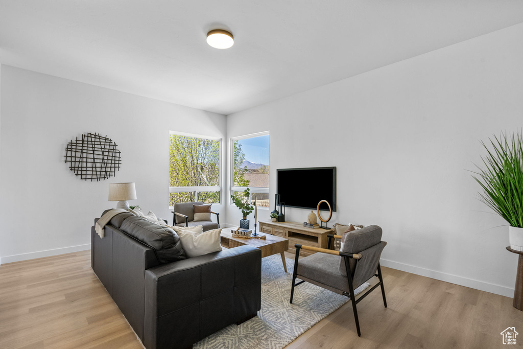 Living area with baseboards and light wood finished floors