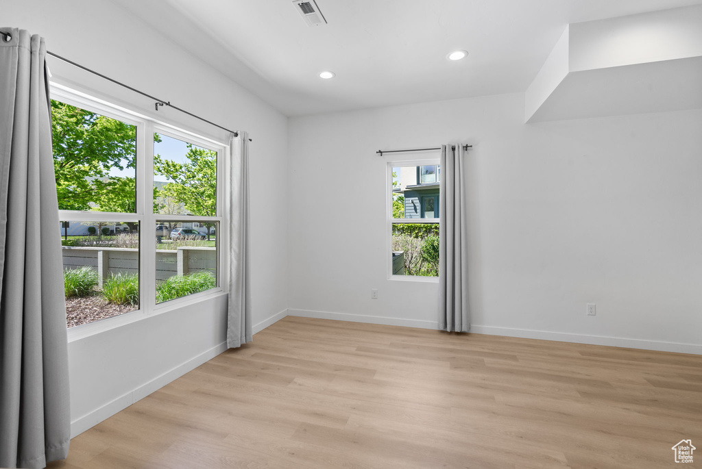 Unfurnished room with visible vents, recessed lighting, light wood-style floors, and baseboards