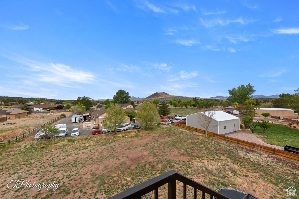 View of yard featuring fence and a mountain view