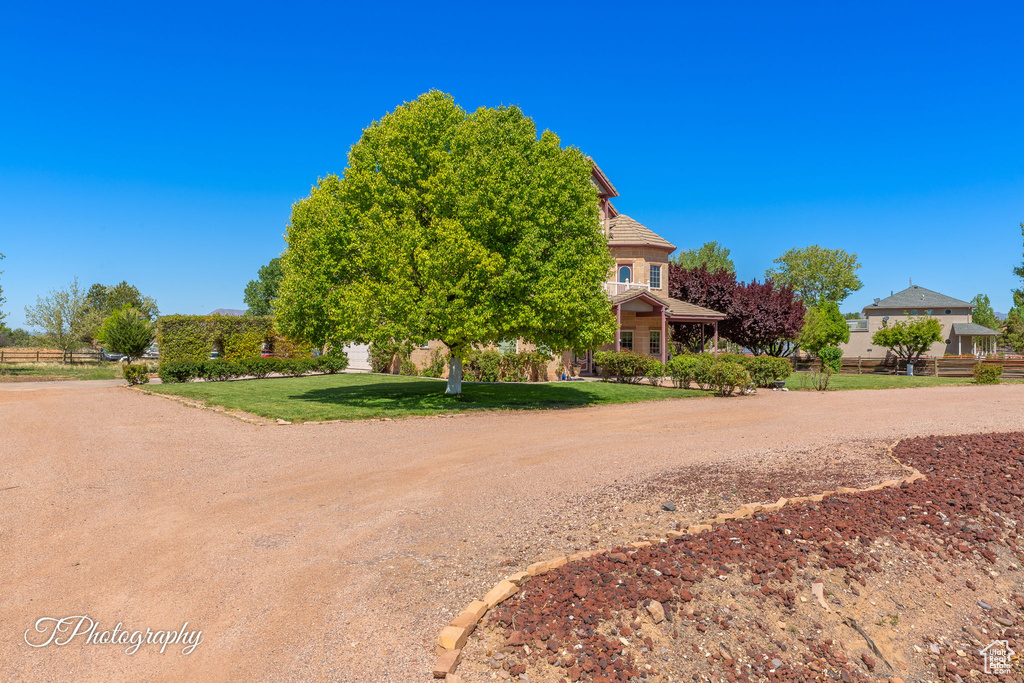 View of community featuring fence and a lawn