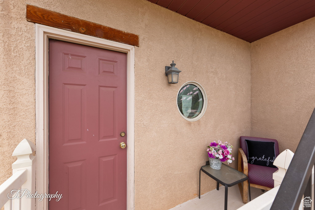 Entrance to property with stucco siding