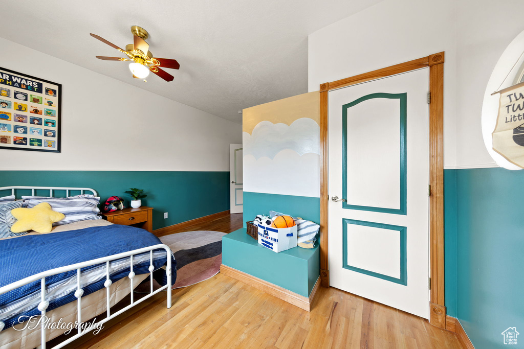 Bedroom with baseboards, ceiling fan, and wood finished floors