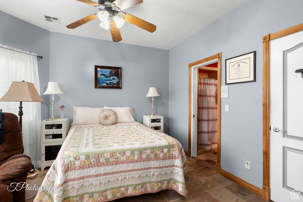 Bedroom with baseboards, ceiling fan, and visible vents