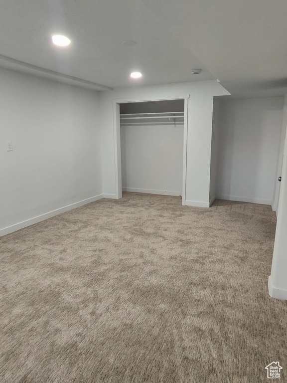 Unfurnished bedroom with light carpet, recessed lighting, a closet, and baseboards