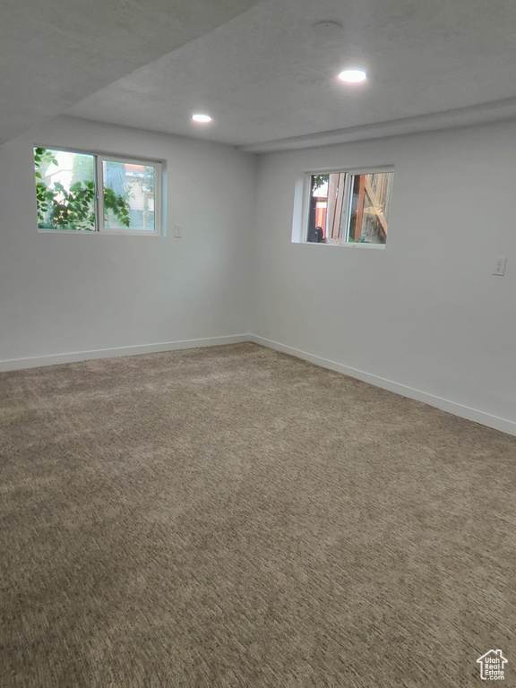 Basement with recessed lighting, baseboards, and carpet