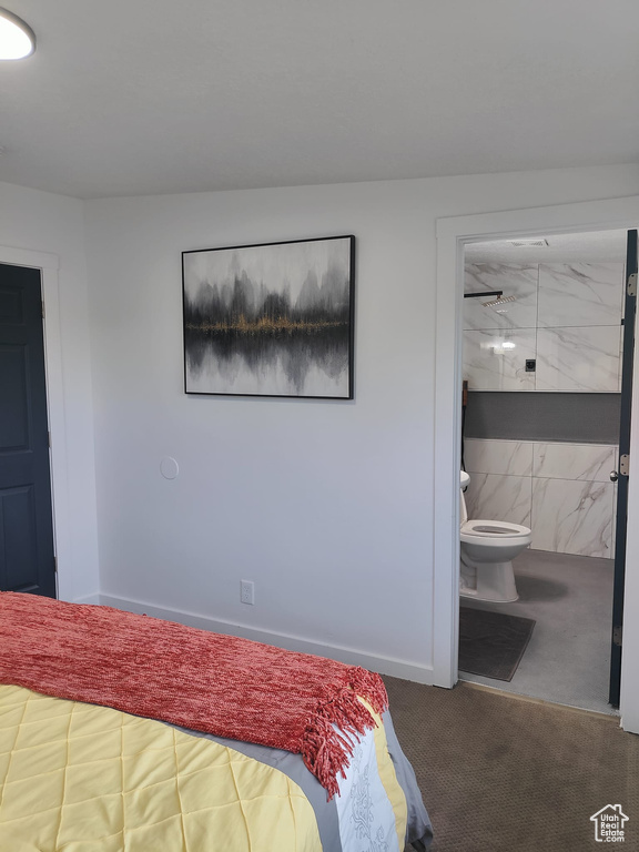 Bedroom with carpet flooring, ensuite bath, and baseboards