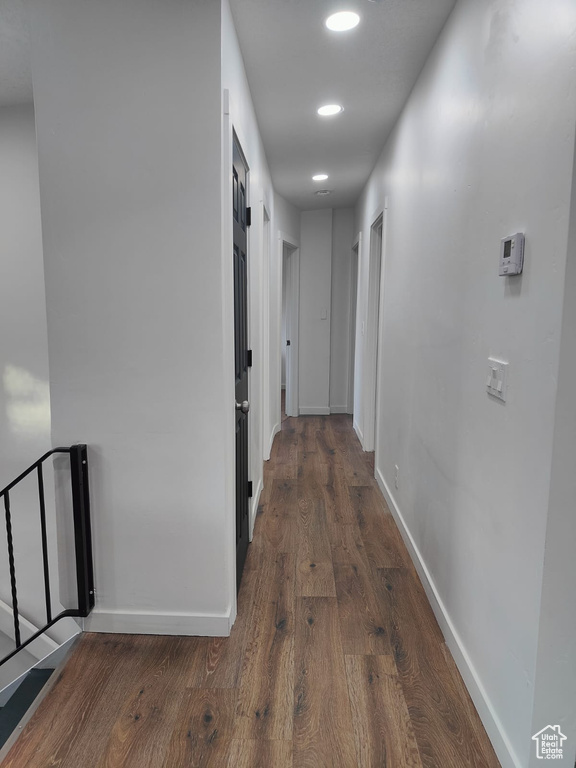 Hallway with wood finished floors, baseboards, and recessed lighting