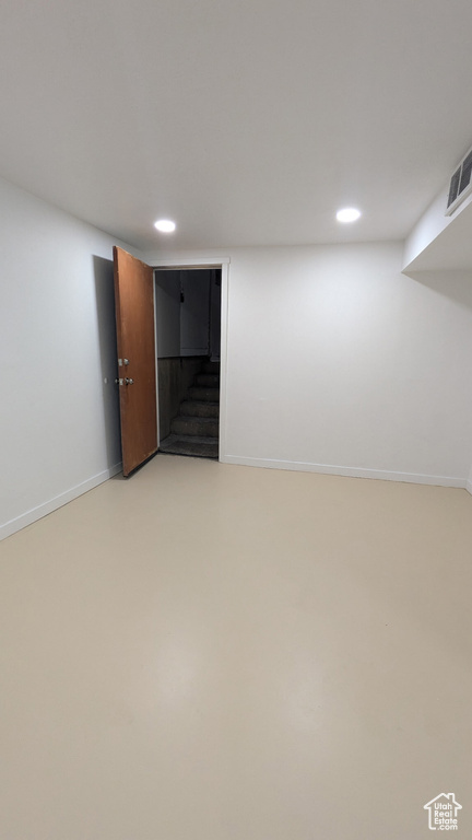 Finished basement featuring stairway, baseboards, recessed lighting, and visible vents