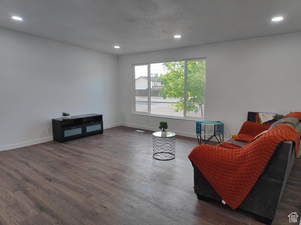 Sitting room featuring wood finished floors, recessed lighting, baseboards, and a textured ceiling