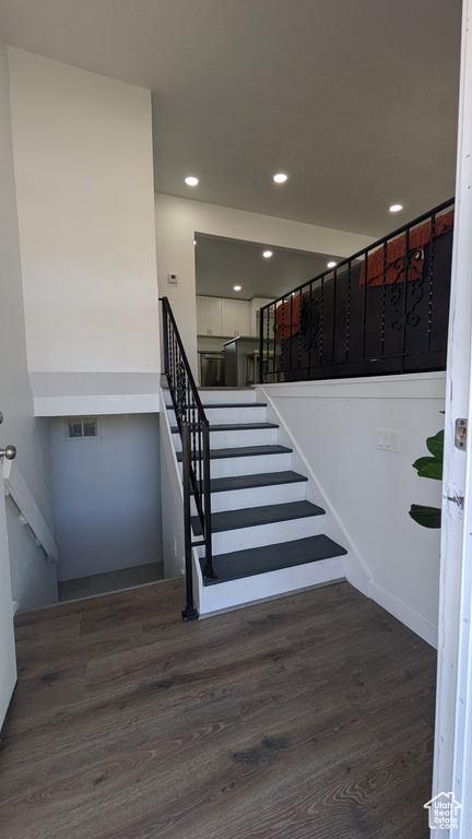 Stairs featuring visible vents, recessed lighting, and wood finished floors