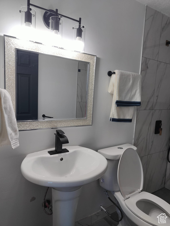 Bathroom featuring toilet and a tile shower