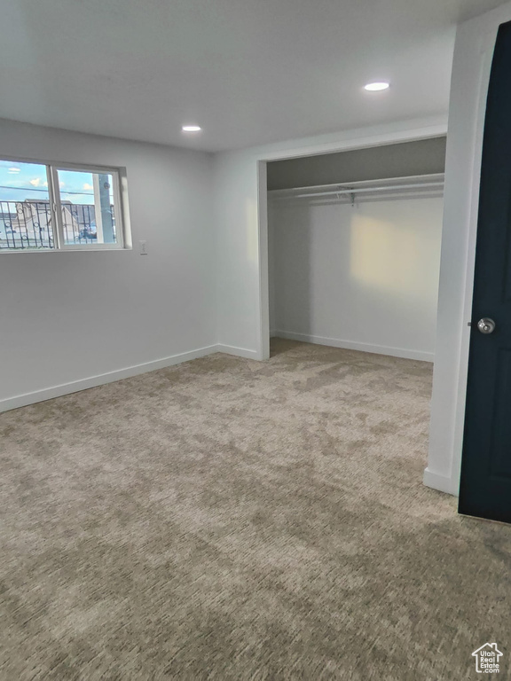 Unfurnished bedroom featuring carpet floors, baseboards, recessed lighting, and a closet