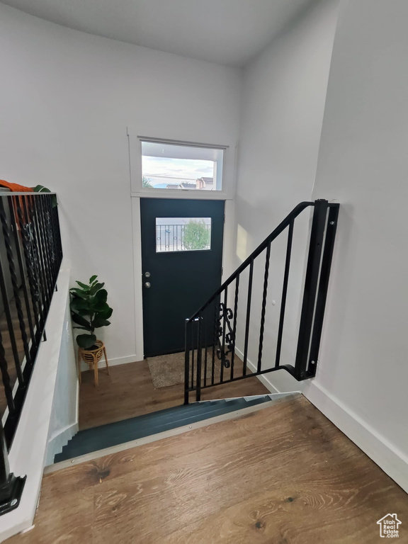Foyer entrance with baseboards and wood finished floors