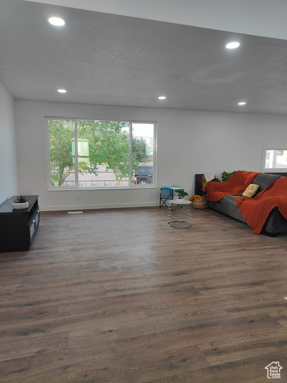 Living room featuring recessed lighting, dark wood finished floors, and baseboards