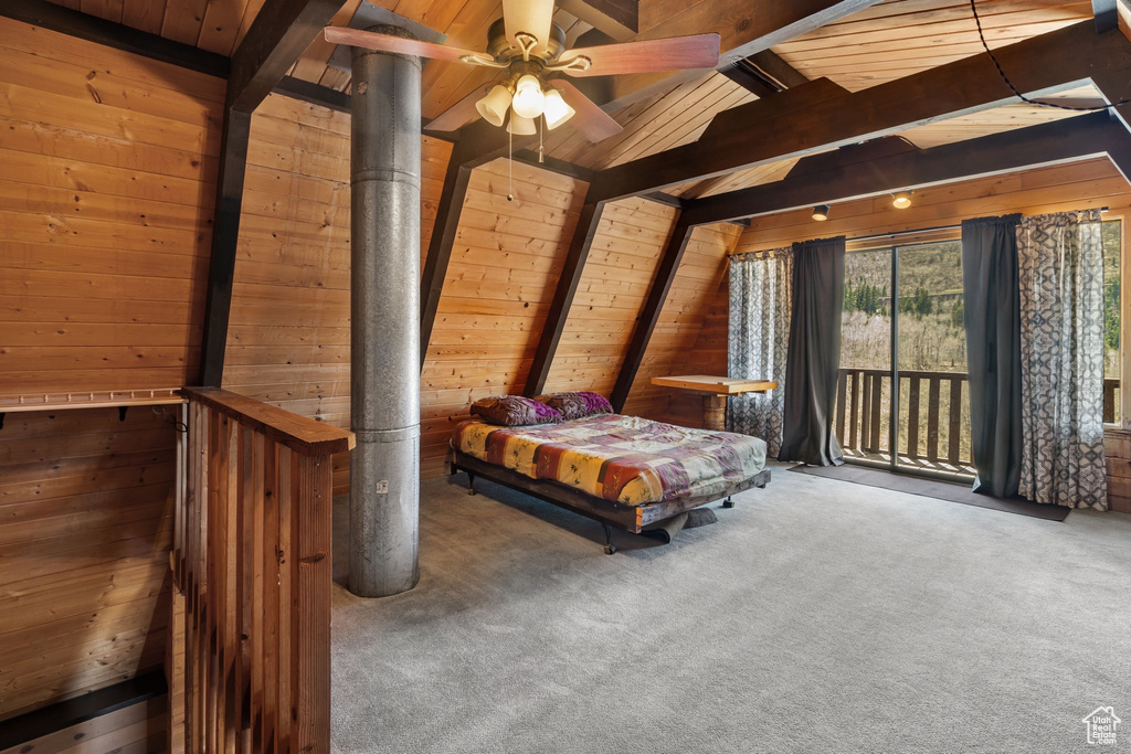 Bedroom with wood ceiling, lofted ceiling with beams, wooden walls, access to outside, and carpet flooring