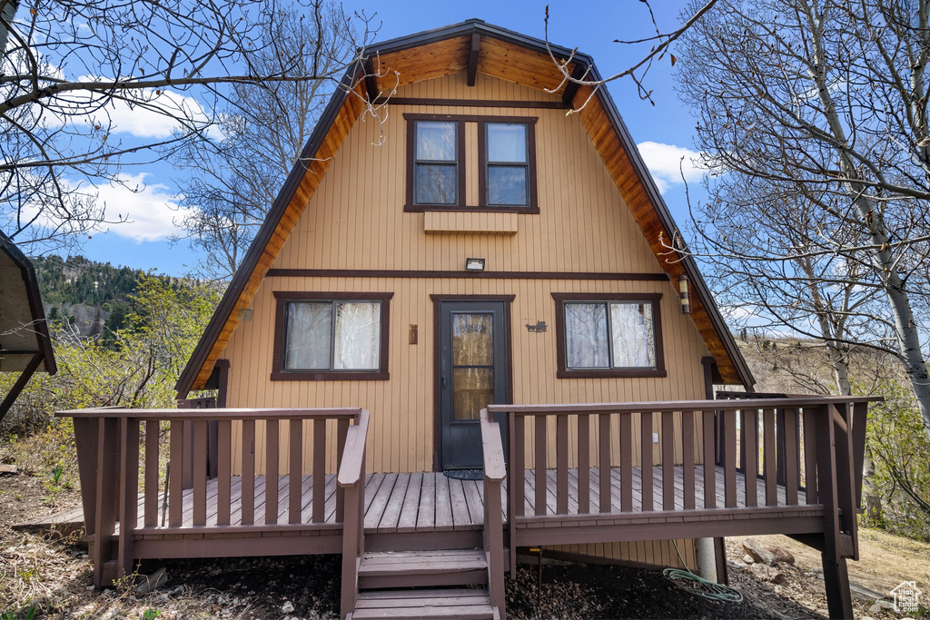 Rear view of house featuring a wooden deck