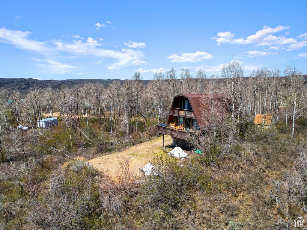 Birds eye view of property with a wooded view
