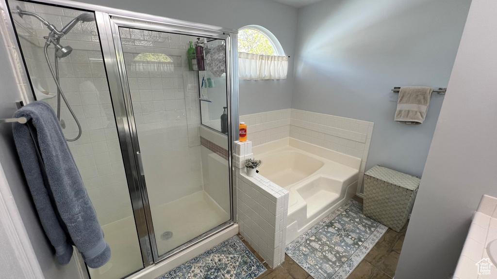 Full bath featuring a bath and a shower stall