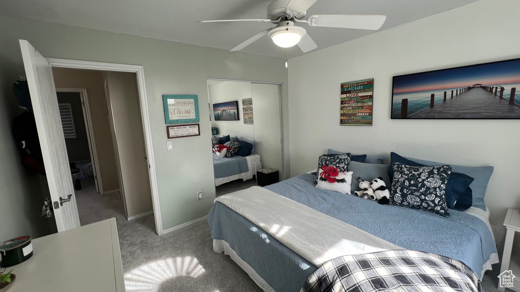 Bedroom featuring a ceiling fan, baseboards, carpet, and a closet