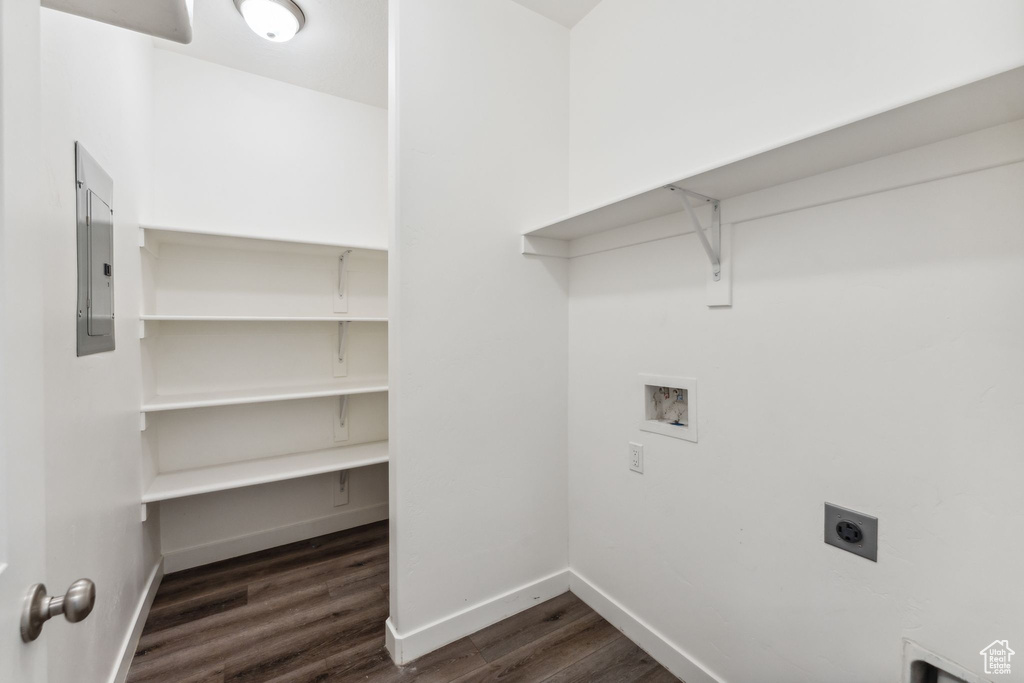 Laundry area with dark wood-style flooring, laundry area, washer hookup, baseboards, and electric dryer hookup