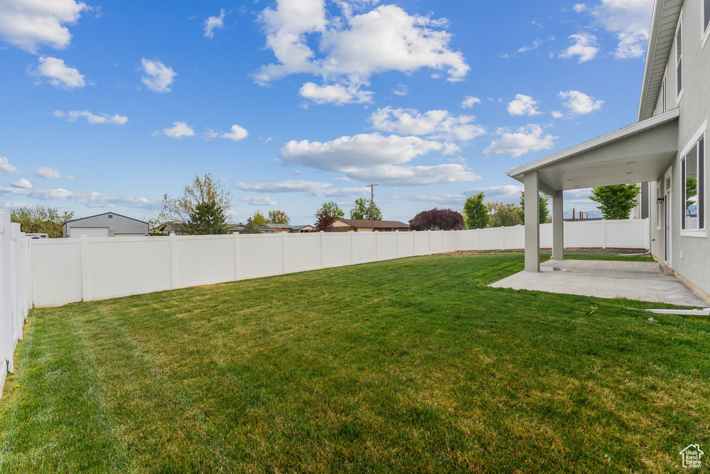 View of yard with a patio and a fenced backyard