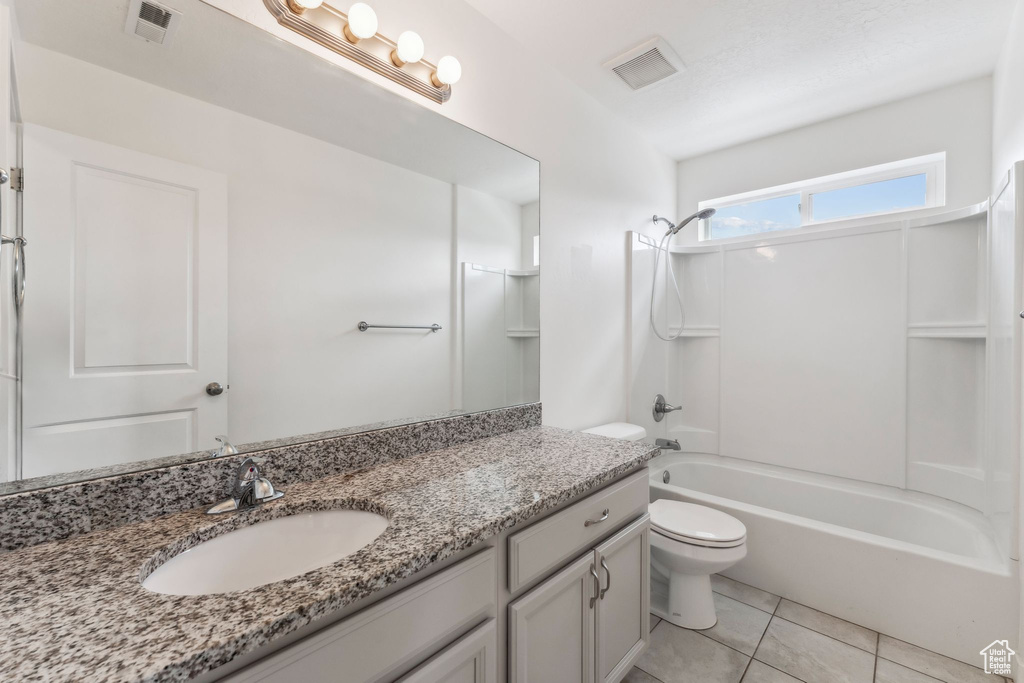 Bathroom featuring vanity, washtub / shower combination, toilet, and visible vents