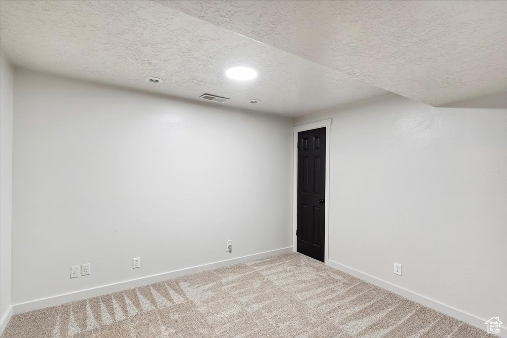 Empty room with baseboards, carpet floors, recessed lighting, and a textured ceiling