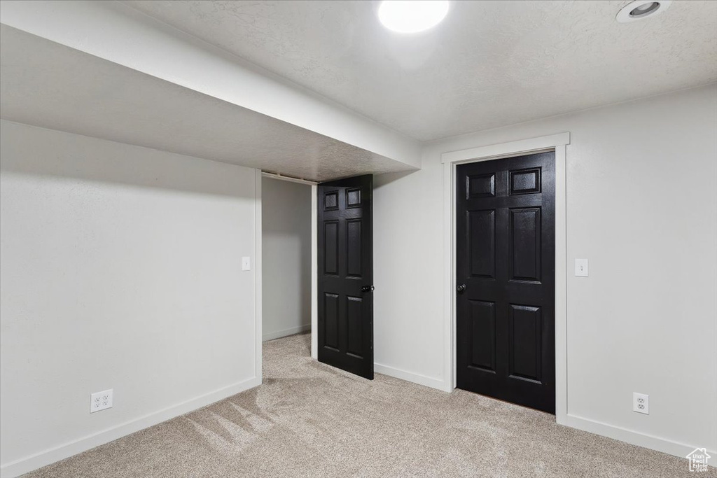 Finished basement featuring baseboards and carpet flooring