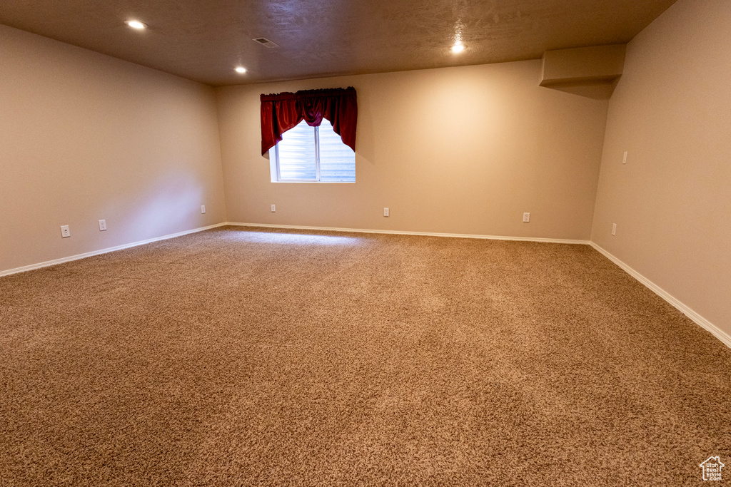 Spare room with recessed lighting, carpet, baseboards, and visible vents