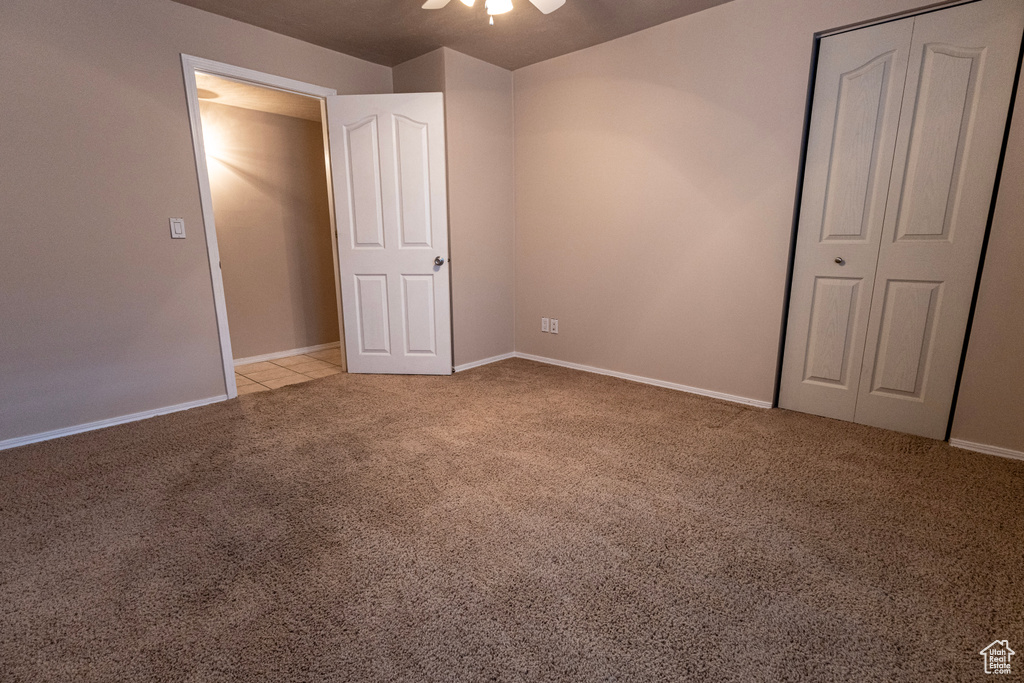 Unfurnished bedroom with carpet floors, a ceiling fan, and baseboards