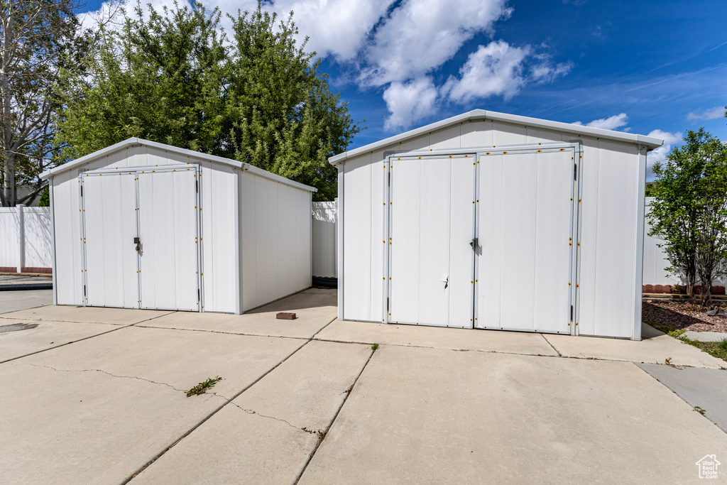 View of shed featuring fence