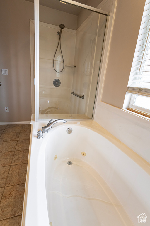 Full bath featuring walk in shower and a tub with jets