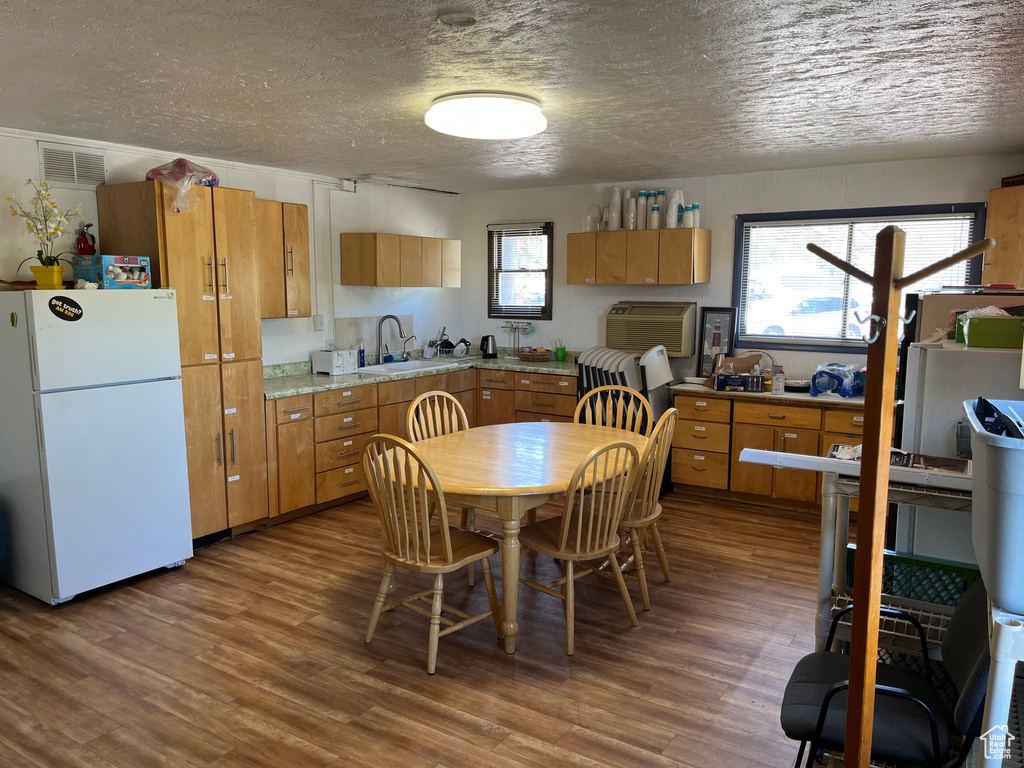 Kitchen with visible vents, freestanding refrigerator, a textured ceiling, and light countertops