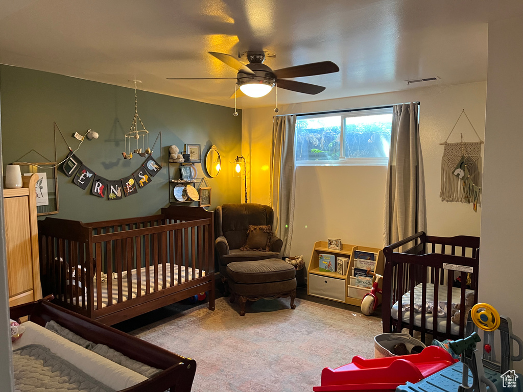 Bedroom featuring visible vents, a ceiling fan, and carpet floors