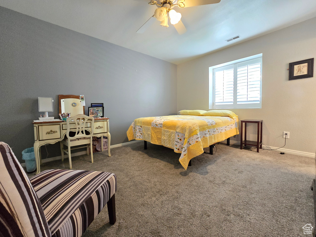 Bedroom with baseboards, carpet flooring, ceiling fan, and visible vents