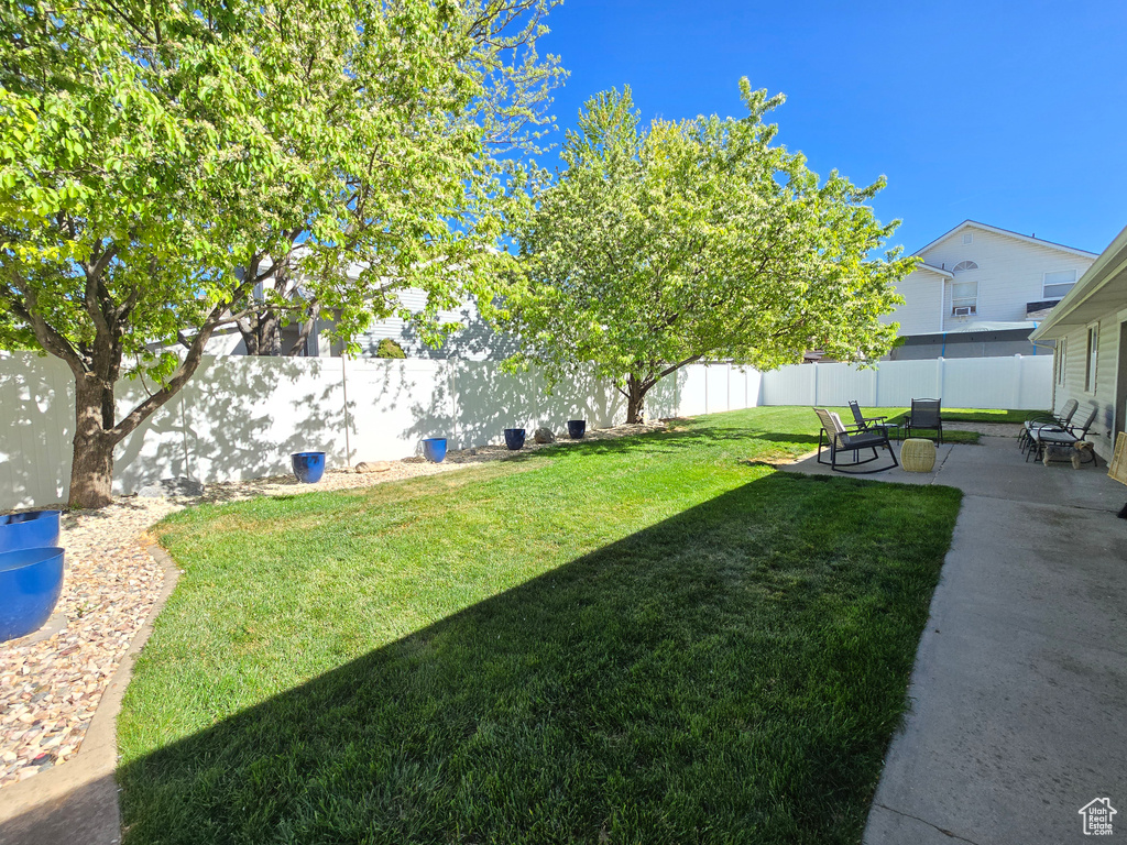 View of yard featuring a patio and a fenced backyard