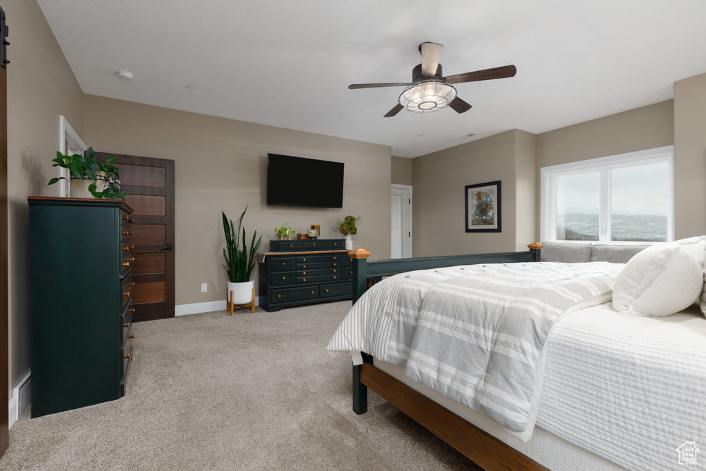 Bedroom featuring light colored carpet and ceiling fan