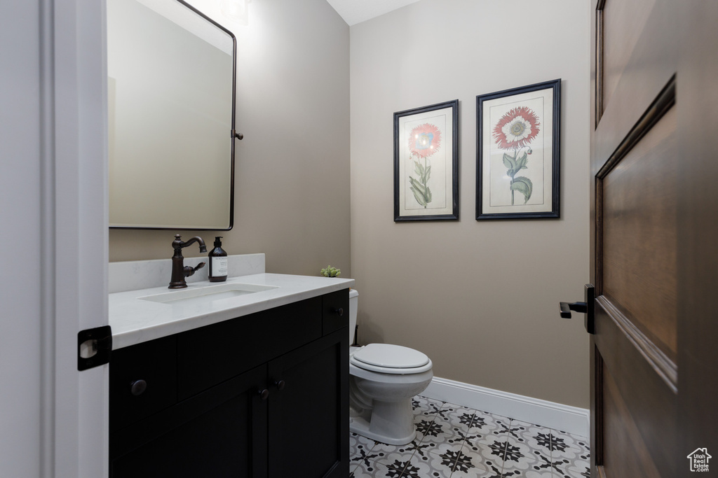 Bathroom with vanity, tile patterned flooring, and toilet