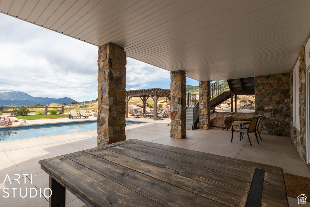 View of patio with a pergola and a mountain view