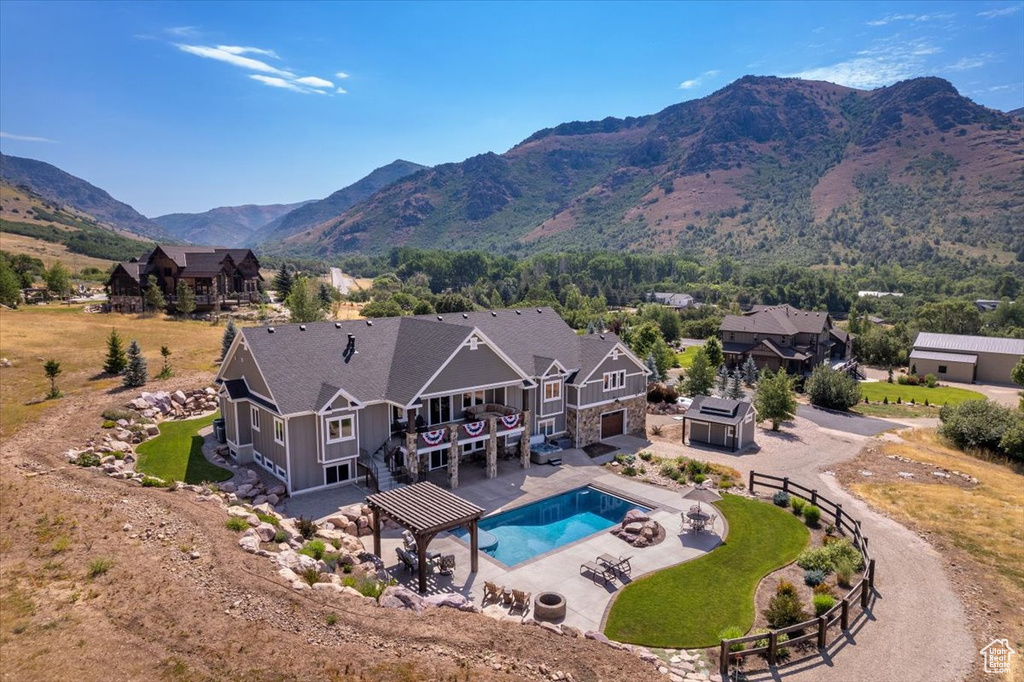 View of swimming pool featuring a mountain view, area for grilling, and a pergola