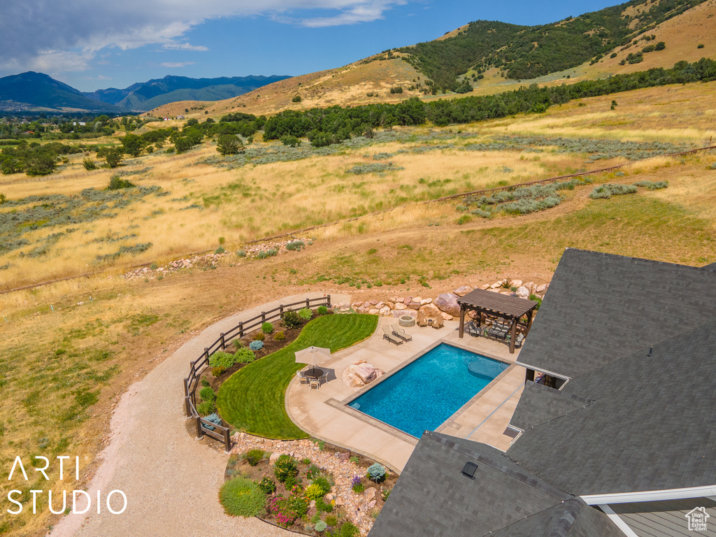 View of pool featuring a mountain view, a pergola, and a patio