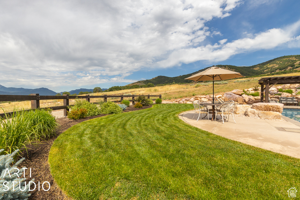 View of yard with a pergola, a mountain view, a patio area, and a rural view